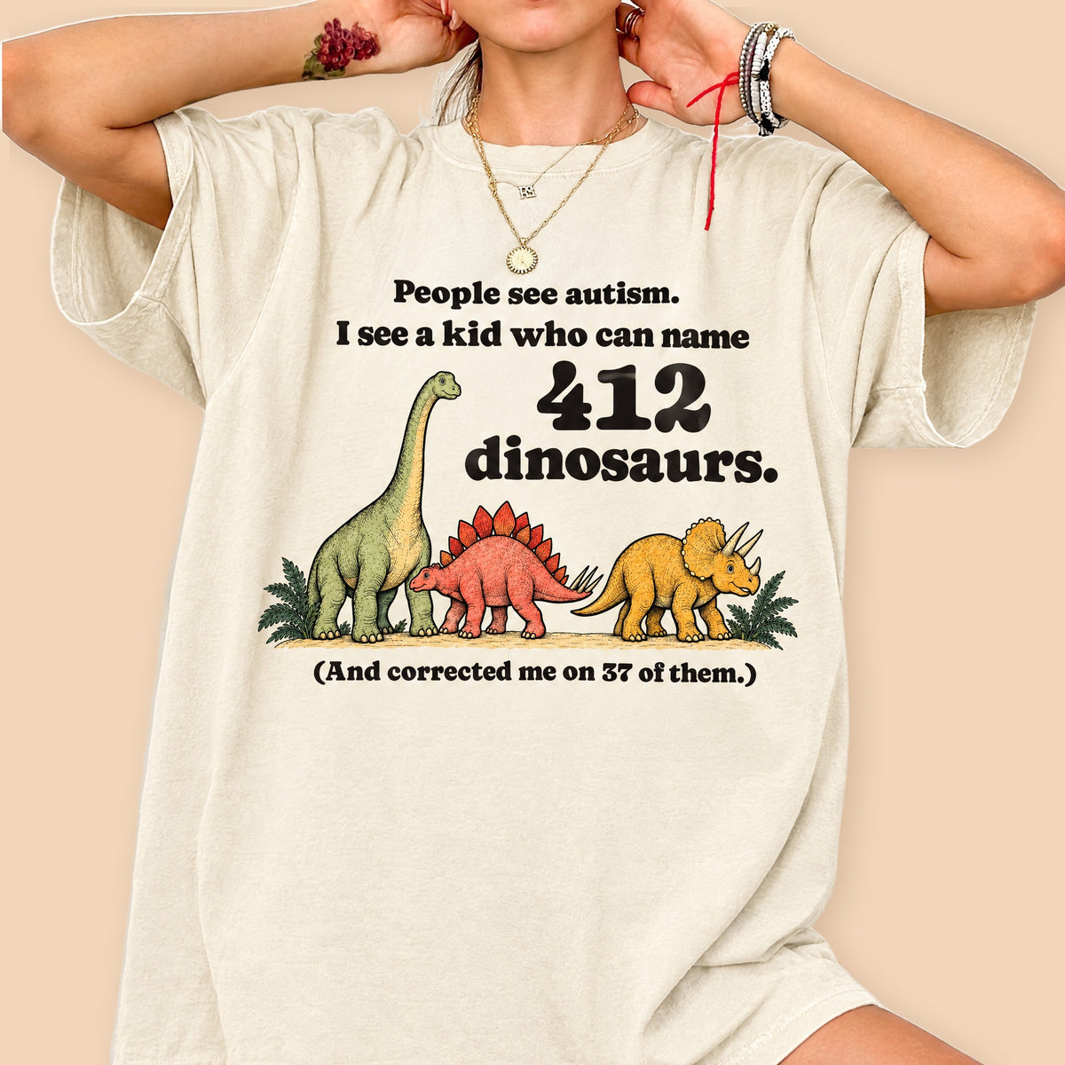 Woman wearing the oversized ivory 412 Dinosaurs tee